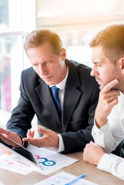 two-businessmen-working-on-tablet-with-full-spectrum-seo-audits-in-background