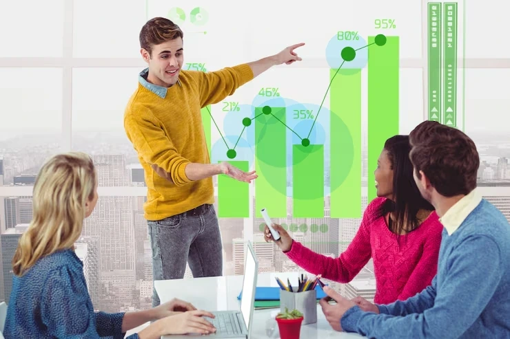 Professionals gathered around a table, focused on a laptop, representing teamwork at a Digital Marketing Agency in Italy.