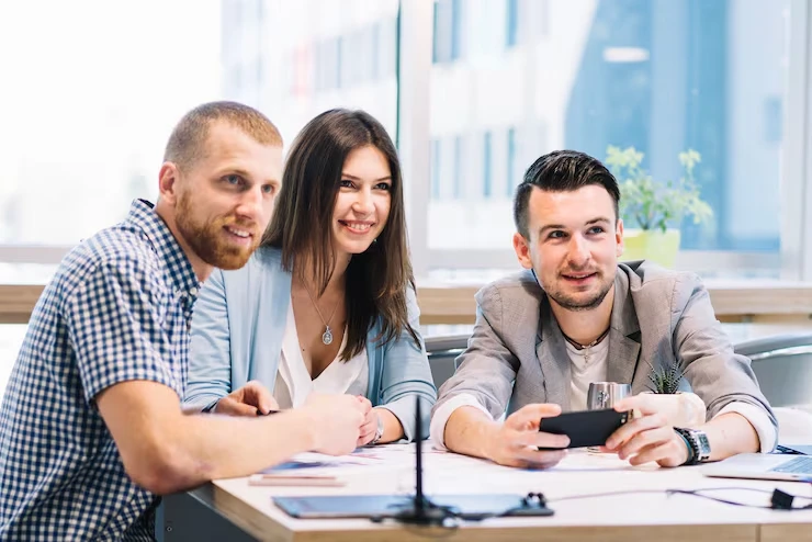 Three business professionals collaborating on local SEO strategy in modern London office setting