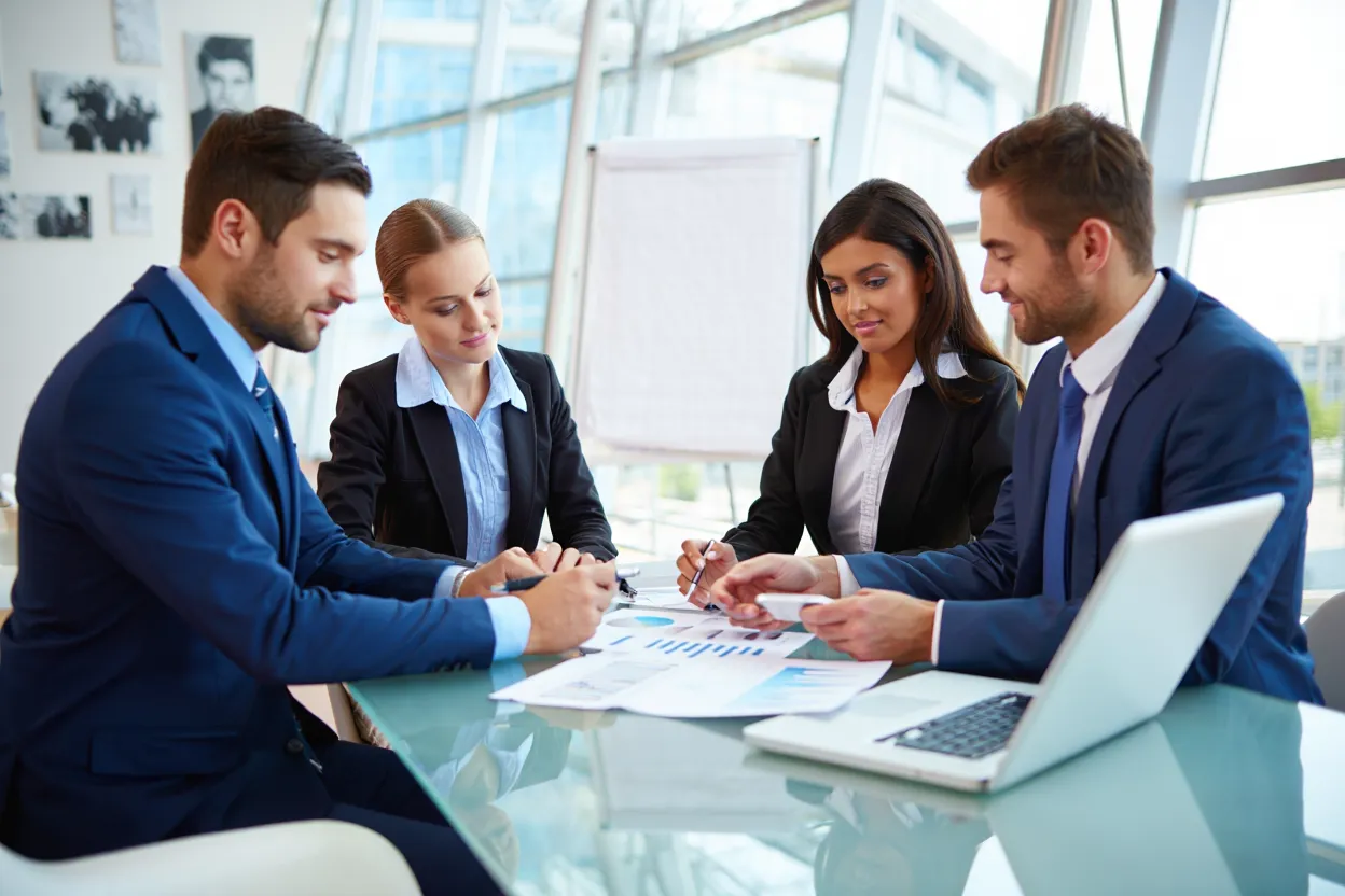 Professional team reviewing SaaS directory submission reports and performance charts during strategy meeting