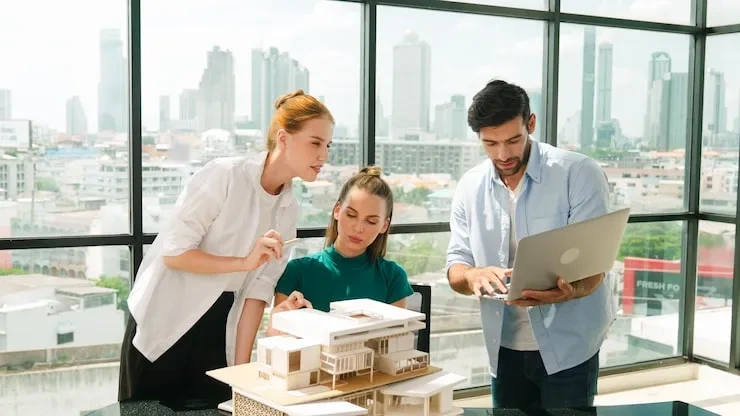 Team reviewing architectural model and reports